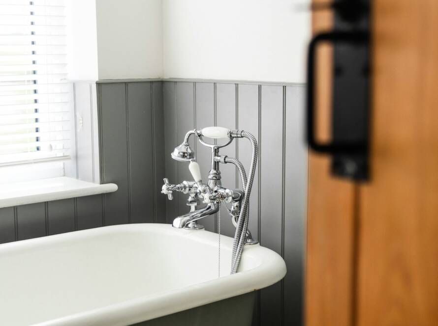 a bathroom with a claw foot tub and a wooden door